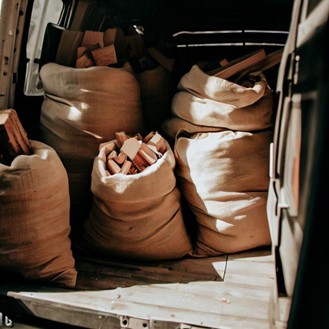 Bags of wood being delivered on a van